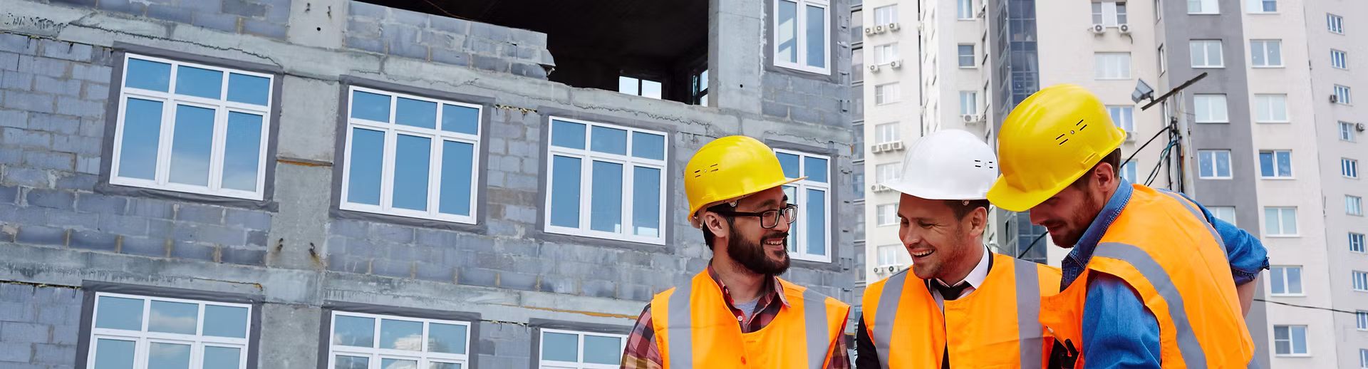 Construction workers checking the blueprint plan