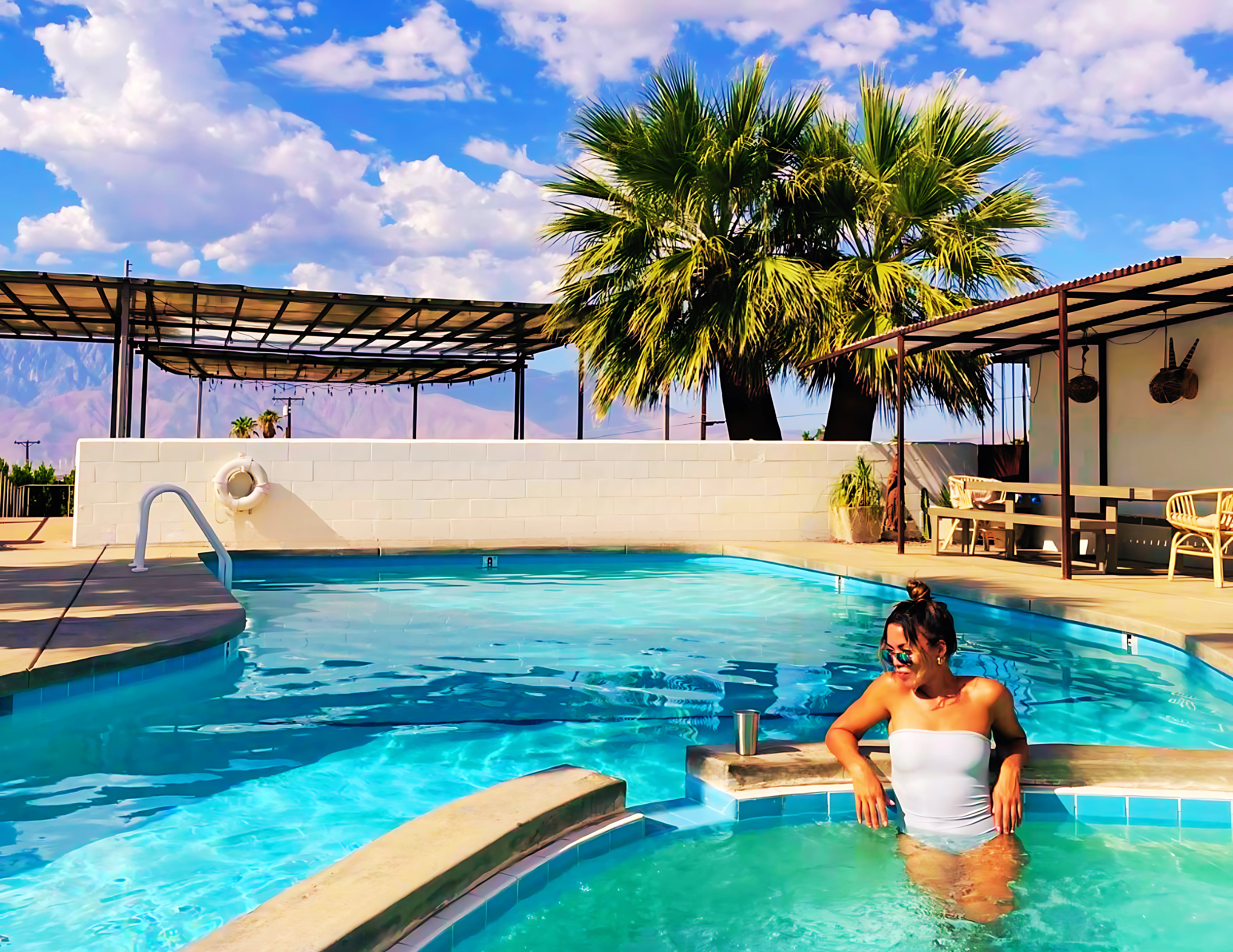 Woman relaxing in mineral hot tub at Miracle Manor — healing waters of Desert Hot Springs