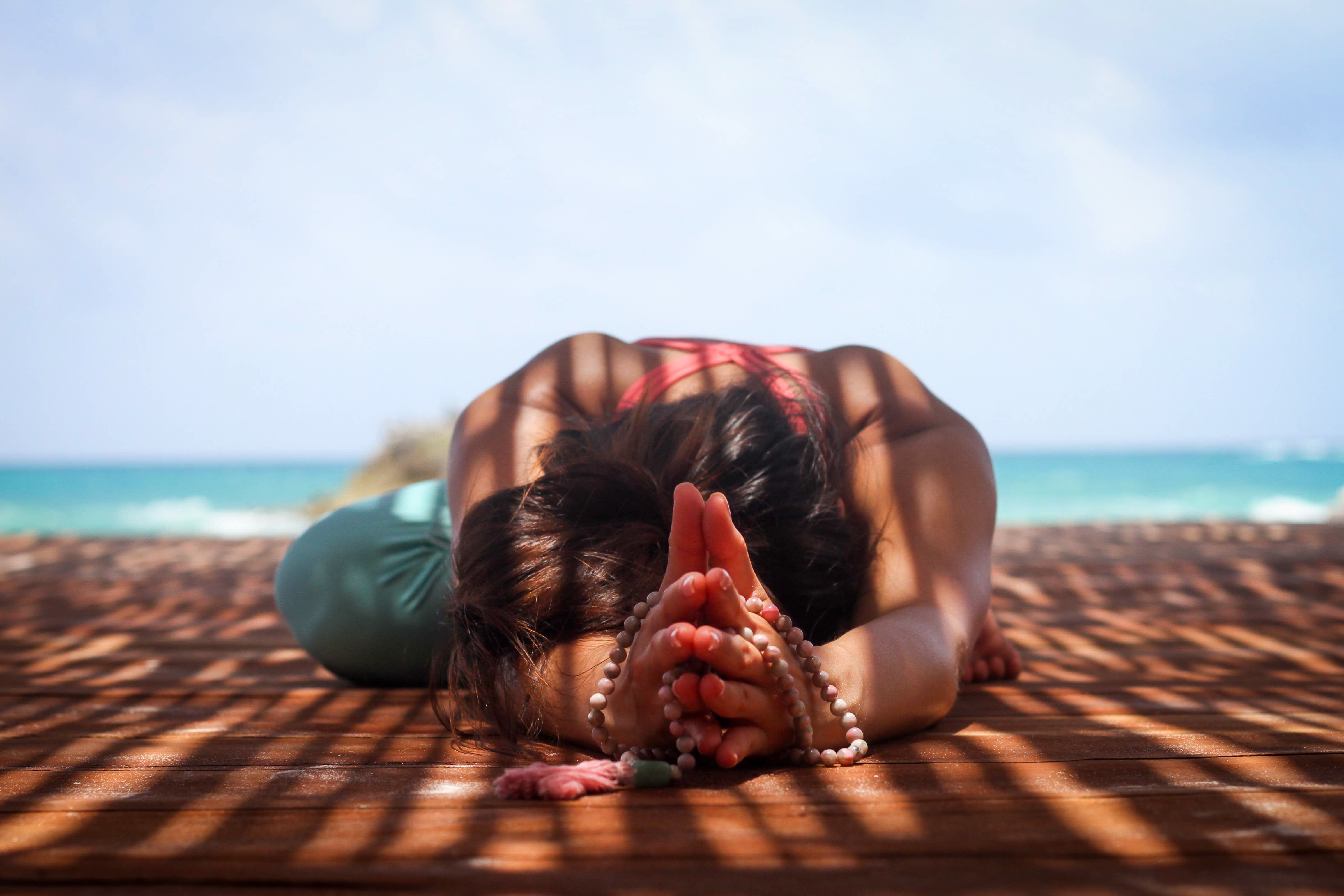 Peaceful yoga session with instructor providing gentle assistance to student in mountain pose