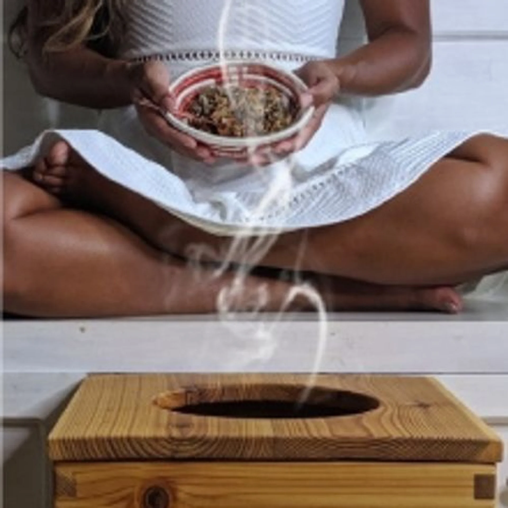 Smiling woman relaxing during spa therapy session with warm, natural lighting
