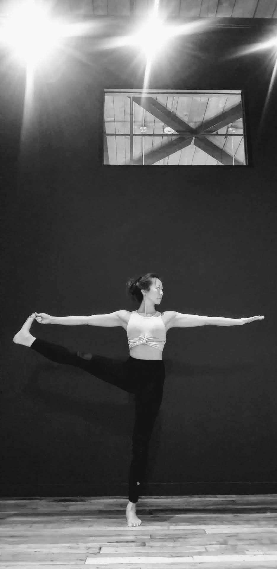 Serene yoga practitioner in perfect balance pose demonstrating mindful movement and inner peace