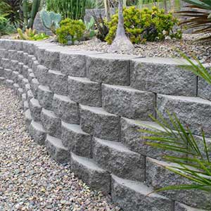 Completed terraced retaining wall with plantings above brick structure